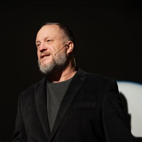 Alex Kasper speaking on stage