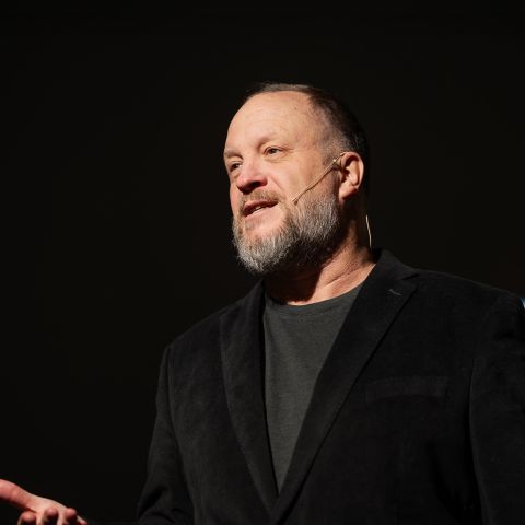 Alex Kasper speaking on stage